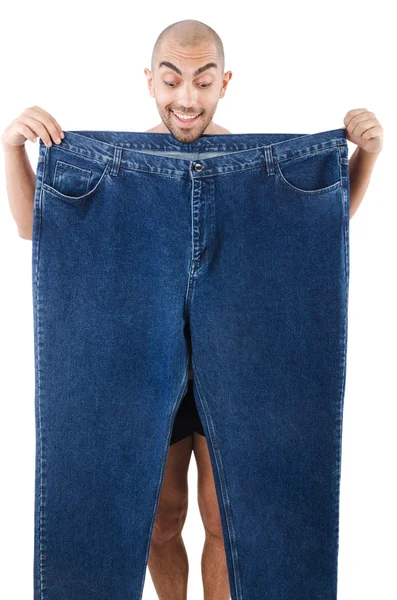 Mannen i bantning koncept med överdimensionerade jeans — Stockfoto