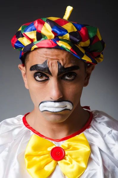 Sad clown against dark background — Stock Photo, Image