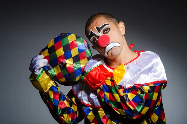 Sad clown against dark background — Stock Photo, Image