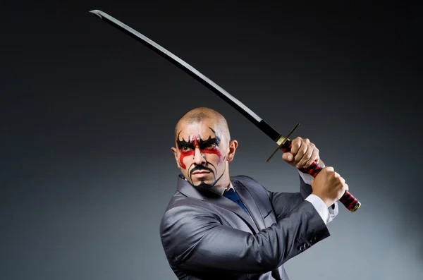 Man with face paint and sword — Stock Photo, Image