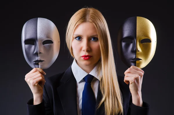 Woman with two masks in hypocrisy concept — Stock Photo, Image