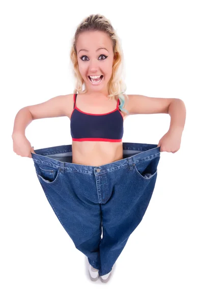 Kvinna i bantningskoncept med stora jeans — Stockfoto