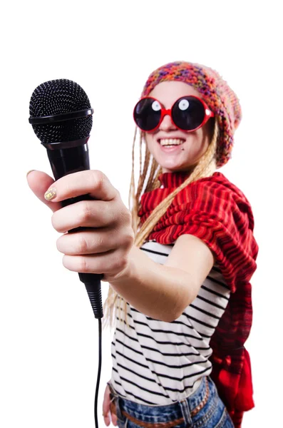 Young female singer with mic on white — Stock Photo, Image