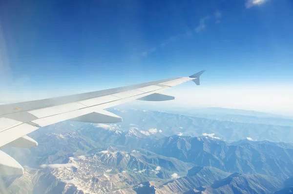 Airplane wing out of window — Stock Photo, Image