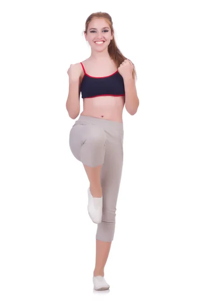 Молодая женщина делает упражнения на белом — стоковое фото
