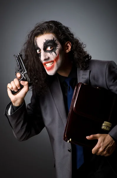 Joker with gun and briefcase — Stock Photo, Image