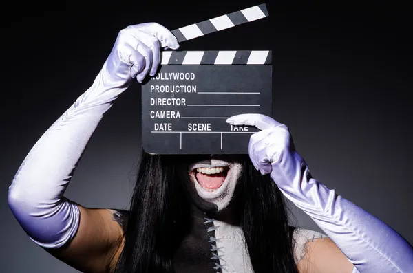 Scary monster with movie board — Stock Photo, Image