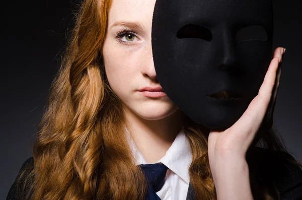 Woman with mask in hypocrisy concept — Stock Photo, Image