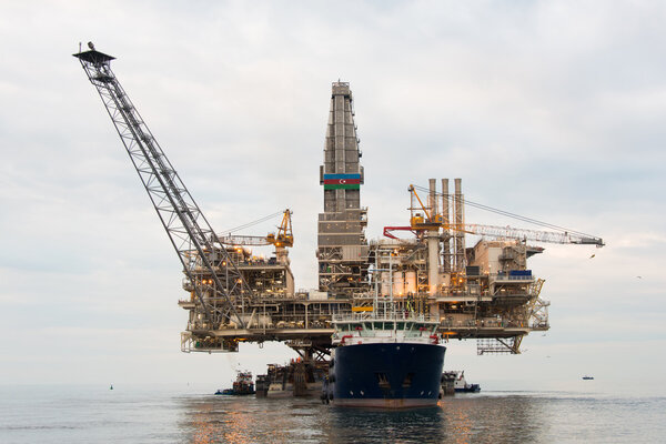 Oil rig being tugged in the sea