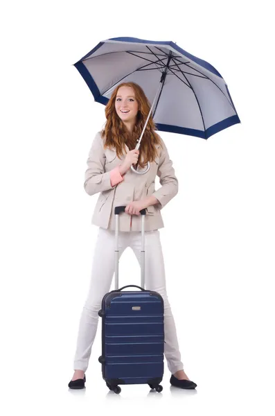 Жінка готується до відпустки з валізою на білому — стокове фото