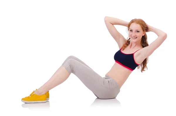 Mladá sportovní žena dělá cvičení na bílém pozadí — Stock fotografie