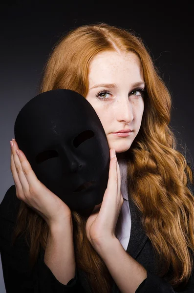 Woman with mask in hypocrisy concept — Stock Photo, Image