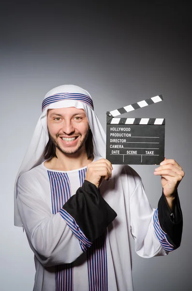 Arab businessman with movie board — Stock Photo, Image