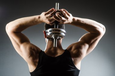 vücut geliştirmeci dumbbells ile