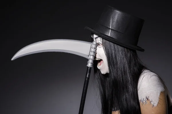 Woman in halloween costume with scythe — Stock Photo, Image