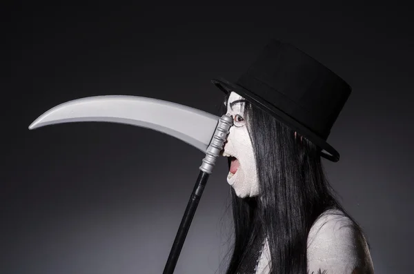 Woman in halloween concept with scythe — Stock Photo, Image