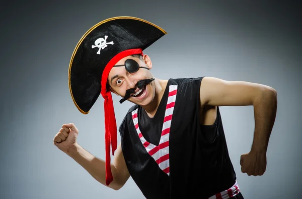 Funny pirate in the dark studio — Stock Photo, Image