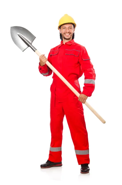 Человек в красном комбинезоне с лопатой — стоковое фото