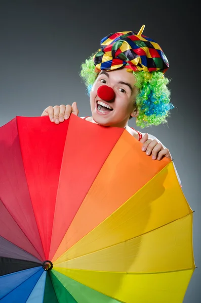 Funny clown with colourful umbrella — Stock Photo, Image