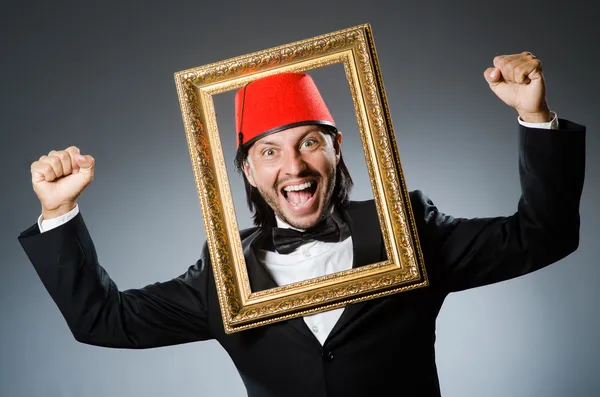 Man with fez  hat and picture frame — Stock Photo, Image