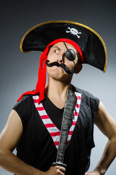 Funny pirate in the dark studio — Stock Photo, Image