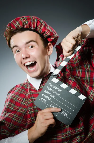 Divertido escocés con película clapboard —  Fotos de Stock