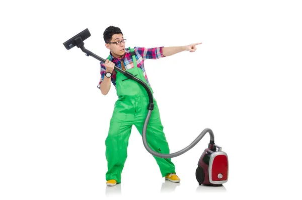 Vtipný muž v zelených kombinézách vakuové čištění — Stock fotografie