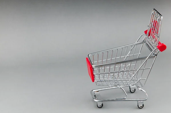 Shopping cart on seamless background — Stock Photo, Image