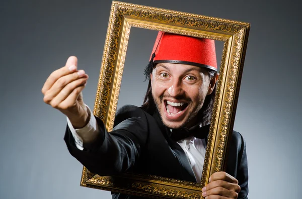 Man with fez  hat and picture frame — Stock Photo, Image