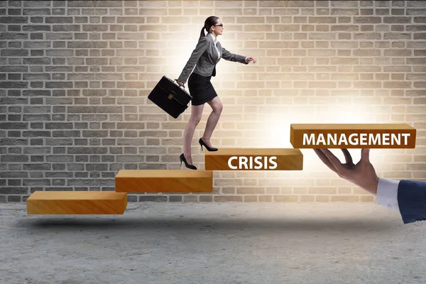 Crisis management concept with climbing businesswoman