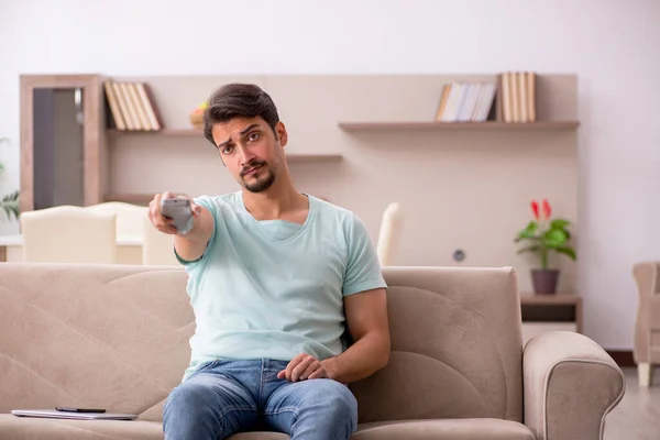 Young man student watching tv at home — Stock Photo, Image