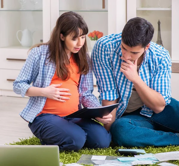 Young family in budget planning concept — Stock Photo, Image