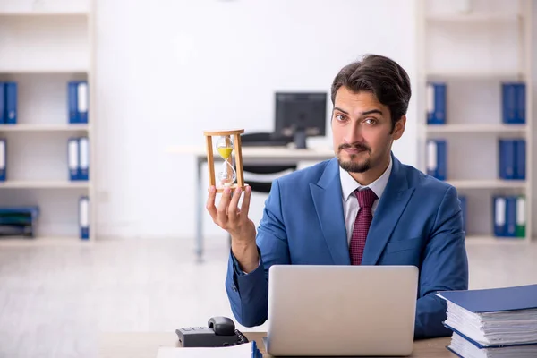 Young male employee in time management concept — Stock Photo, Image