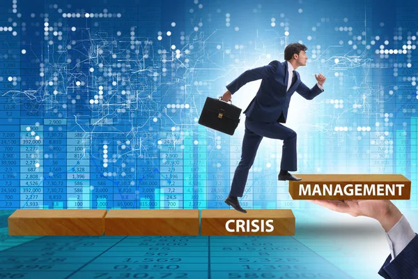 Crisis management concept with climbing businessman — Stock Photo, Image