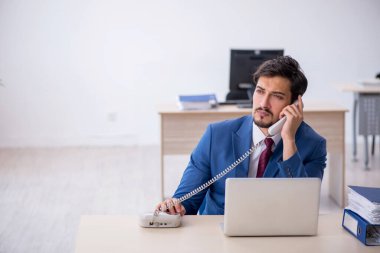 Ofiste çalışan genç bir erkek.