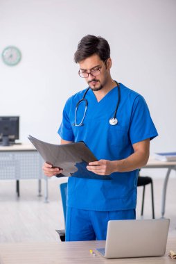 Klinikte çalışan genç bir erkek radyolog.