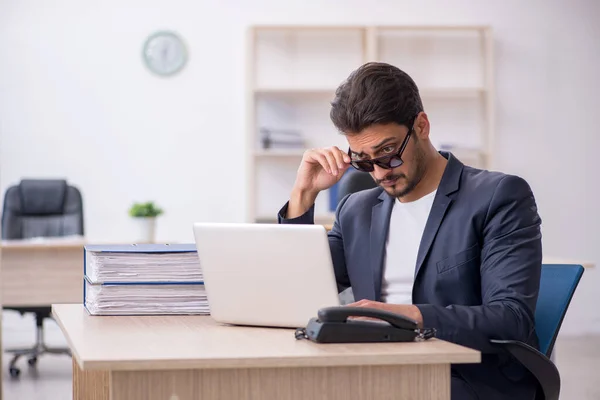 Young handsome employee working in the office — Stock Photo, Image