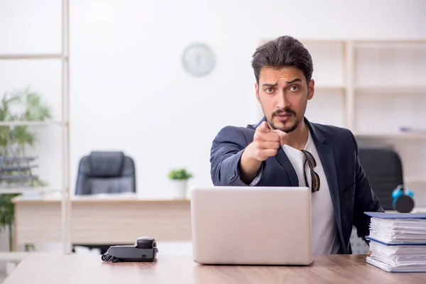 Young handsome employee working in the office — Stock Photo, Image