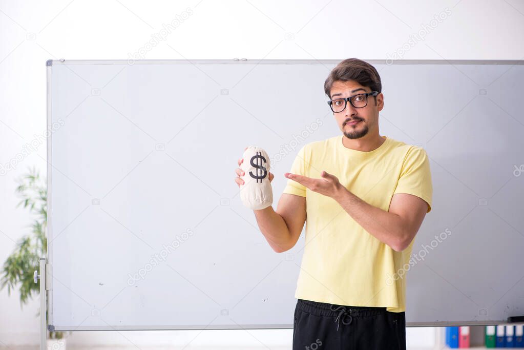 Young male student holding moneybag