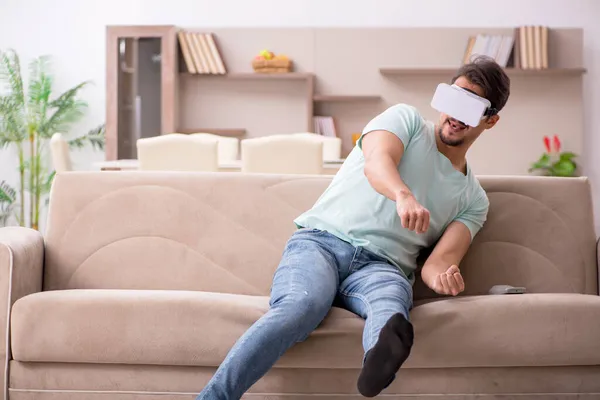 Young man student wearing virtual glasses at home — Stock Photo, Image