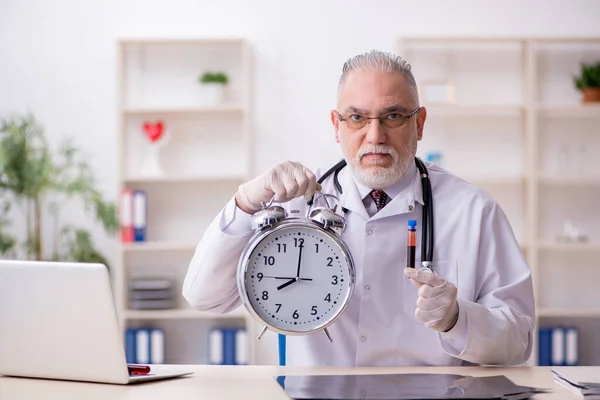 Zaman yönetimi konseptinde yaşlı erkek doktor — Stok fotoğraf