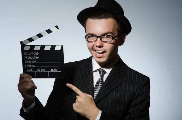 Man with movie clapperboard and hat — Stock Photo, Image
