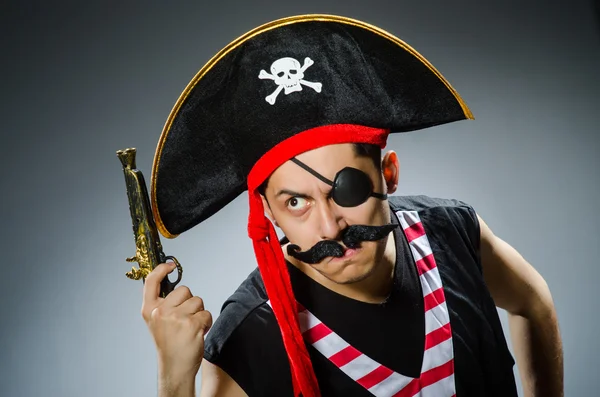 Funny pirate in the dark studio — Stock Photo, Image