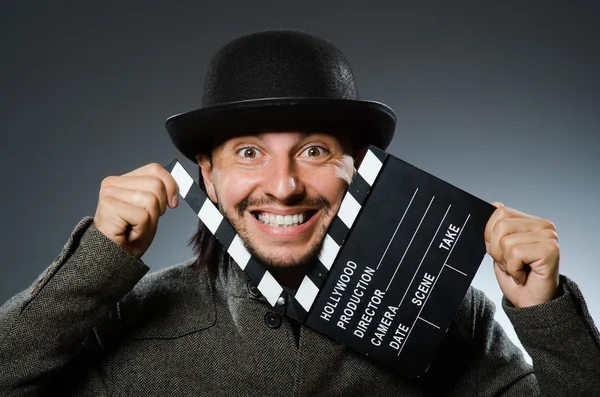 Man with movie clapperboard and hat — Stock Photo, Image