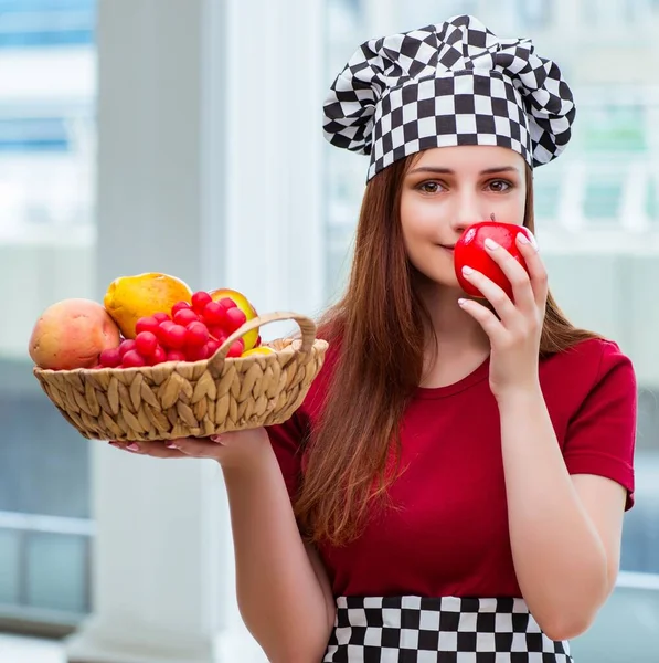 Young cook with fruits in the kitchen — Stock Photo, Image