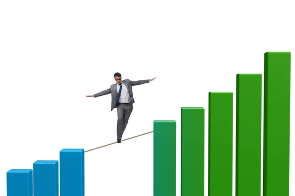 Empresário andando em corda apertada entre gráfico de barras — Fotografia de Stock