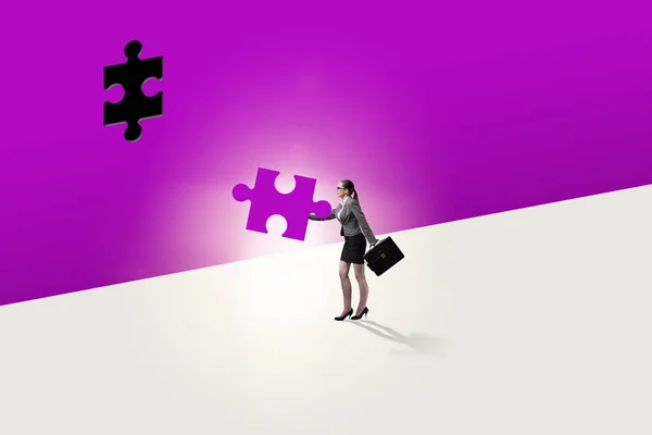 Businesswoman putting missing jigsaw puzzle piece — Stock Photo, Image