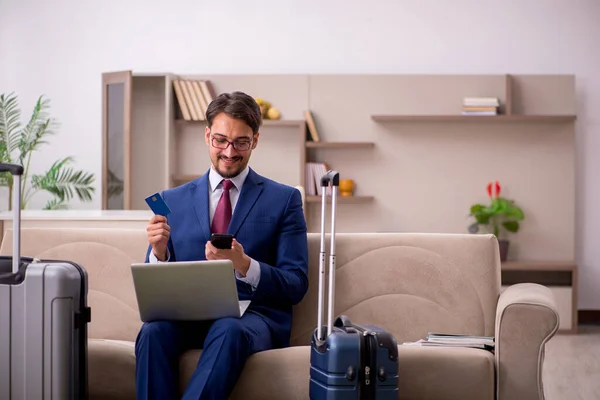 Young businessman preparing for trip at home