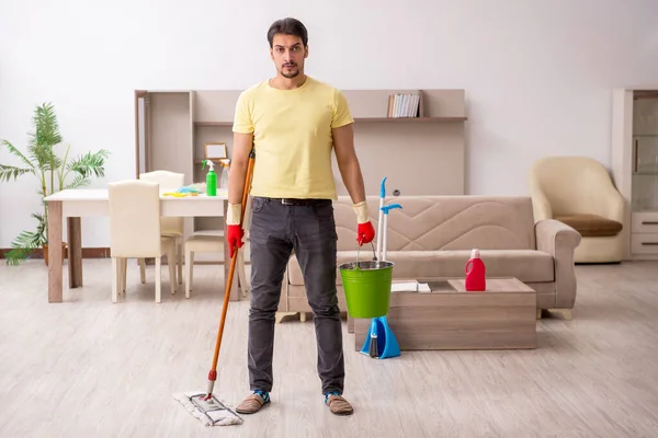 Jonge mannelijke aannemer schoonmaken van het huis — Stockfoto