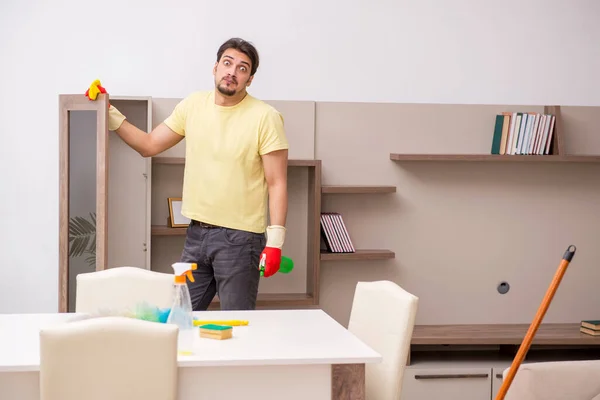 Young male contractor cleaning the house — Stock Photo, Image